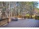 Relax on this expansive, stained-wood back deck featuring decorative railings and views of a serene, wooded backyard at 103 Tremont Cir, Chapel Hill, NC 27516