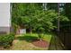 This backyard retreat includes a well-maintained lawn, landscaping, mature trees, and a charming stair-accessed deck at 103 Tremont Cir, Chapel Hill, NC 27516