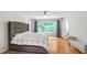 Spacious main bedroom with wood floors, natural light, and gray accents at 103 Tremont Cir, Chapel Hill, NC 27516