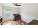 Cozy bedroom featuring a wooden floor, ceiling fan, and bright window at 103 Tremont Cir, Chapel Hill, NC 27516