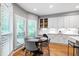 Bright breakfast nook features a round table, wood floors, and white cabinets at 103 Tremont Cir, Chapel Hill, NC 27516