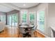 Bright breakfast nook features a round table, wood floors, and a view of the backyard at 103 Tremont Cir, Chapel Hill, NC 27516