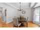 Cozy dining room featuring hardwood floors, tray ceiling, and chandelier lighting at 103 Tremont Cir, Chapel Hill, NC 27516