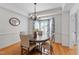 Inviting dining room with a wood table, bay window and elegant chandelier at 103 Tremont Cir, Chapel Hill, NC 27516