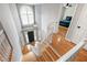 Two-story foyer featuring hardwood floors, natural light, and an elegant chandelier at 103 Tremont Cir, Chapel Hill, NC 27516