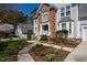 Charming home with brick front, lush landscaping, walkway, and attached garage at 103 Tremont Cir, Chapel Hill, NC 27516