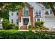 Beautiful two-story home with manicured lawn, brick facade, and welcoming front porch at 103 Tremont Cir, Chapel Hill, NC 27516