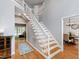Bright hallway with staircase, wood floors, and access to living areas at 103 Tremont Cir, Chapel Hill, NC 27516