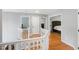 Bright hallway with hardwood floors, white banister, and doorways to bedrooms at 103 Tremont Cir, Chapel Hill, NC 27516