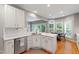 Open-concept kitchen with marble countertops, stainless steel appliances, and a view to a backyard deck at 103 Tremont Cir, Chapel Hill, NC 27516