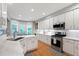 Bright, modern kitchen featuring white cabinetry, stainless steel appliances, and a connected breakfast nook at 103 Tremont Cir, Chapel Hill, NC 27516