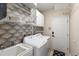 Functional laundry room with wallpaper, white washer and dryer, and storage space at 103 Tremont Cir, Chapel Hill, NC 27516