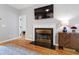 Living room features a fireplace with black mantle and a decorative cabinet for storage and display at 103 Tremont Cir, Chapel Hill, NC 27516