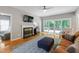 Cozy living room featuring a fireplace, hardwood floors, and sliding glass doors to the backyard at 103 Tremont Cir, Chapel Hill, NC 27516