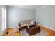 Cozy living room with hardwood floors, futon sofa, and stylish decor at 103 Tremont Cir, Chapel Hill, NC 27516