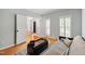 Inviting living room featuring light blue walls, hardwood floors, and bright natural light through window shutters at 103 Tremont Cir, Chapel Hill, NC 27516