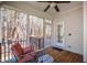 Comfortable screened porch with wood floors, ceiling fan, and wooded views at 103 Tremont Cir, Chapel Hill, NC 27516