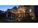 Evening view of backyard featuring an outdoor patio and string lights, perfect for gatherings at 106 Mesquite Dr, Durham, NC 27703