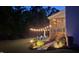 Backyard with patio, string lights, lush greenery, and covered porch, an ideal entertainment space at 106 Mesquite Dr, Durham, NC 27703