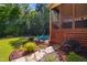 Landscaped backyard with a screened-in porch, dining set, and fire pit, creating an ideal outdoor oasis at 106 Mesquite Dr, Durham, NC 27703