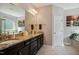Bathroom with dark wood cabinets, granite countertops, double sinks, and a soaking tub at 106 Mesquite Dr, Durham, NC 27703