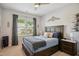 Cozy bedroom with neutral walls, a comfortable bed, and natural light streaming through the windows at 106 Mesquite Dr, Durham, NC 27703