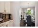 Bright dining area features a wood table, bench seating, and a view of the neighborhood through a window at 106 Mesquite Dr, Durham, NC 27703