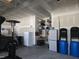 Neat garage with shelving, workbench, storage cabinets, and space for cars, plus heater at 106 Mesquite Dr, Durham, NC 27703