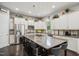 Spacious kitchen with white cabinets, stainless steel appliances, and a large island with barstool seating at 106 Mesquite Dr, Durham, NC 27703