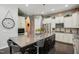 Modern kitchen with white cabinets, stainless steel appliances, and a large center island with seating at 106 Mesquite Dr, Durham, NC 27703