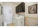 Bright laundry area featuring a washer, dryer, dark cabinets, and a practical drying rack at 106 Mesquite Dr, Durham, NC 27703