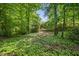 Lush, wooded backyard offers privacy and a serene natural setting at 108 Westport Dr, Cary, NC 27511