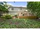 View of the home's rear facade with a beautiful back deck and natural landscaping at 108 Westport Dr, Cary, NC 27511