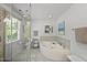 Bathroom with a glass-enclosed shower, jetted tub, and neutral tile flooring at 108 Westport Dr, Cary, NC 27511
