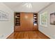 Bedroom featuring a Murphy bed with shelving, hardwood flooring, and a ceiling fan at 108 Westport Dr, Cary, NC 27511
