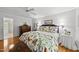 Bright bedroom with hardwood floors, ceiling fan, and colorful bird-themed bedding at 108 Westport Dr, Cary, NC 27511