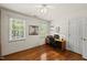 Bright bedroom featuring a wood desk, natural light, and wood floors at 108 Westport Dr, Cary, NC 27511