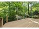Spacious wooden deck surrounded by lush greenery at 108 Westport Dr, Cary, NC 27511