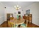 Dining room showcasing hardwood floors, wooden furniture, and a chandelier at 108 Westport Dr, Cary, NC 27511