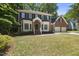 Traditional brick home featuring a well-kept lawn and attached two-car garage at 108 Westport Dr, Cary, NC 27511