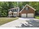 Attractive brick home with a two-car garage, a well-manicured lawn, and mature trees at 108 Westport Dr, Cary, NC 27511