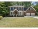 Charming brick home with a well-manicured lawn and lush landscaping at 108 Westport Dr, Cary, NC 27511