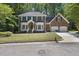 Traditional brick home with manicured front lawn, lush greenery, and a two-car garage at 108 Westport Dr, Cary, NC 27511
