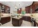 Open kitchen with granite island, stainless appliances, and dark wood cabinets, ideal for entertaining at 108 Westport Dr, Cary, NC 27511