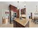 Bright kitchen features granite island, stainless steel refrigerator, and dark wood cabinets at 108 Westport Dr, Cary, NC 27511