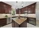 Gourmet kitchen boasts a granite island, stainless steel appliances, and dark wood cabinetry at 108 Westport Dr, Cary, NC 27511