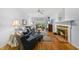 Bright living room featuring a fireplace, comfortable furniture, and large windows at 108 Westport Dr, Cary, NC 27511