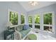 Bright sunroom with tiled floors, several windows, and comfortable seating at 108 Westport Dr, Cary, NC 27511
