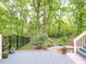 Backyard view showcasing a patio, mature trees, a garden path, and lush greenery at 110 Blackford Ct, Durham, NC 27712