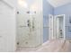 This bathroom features a walk-in shower with glass surround, sleek fixtures and neutral tile at 110 Blackford Ct, Durham, NC 27712